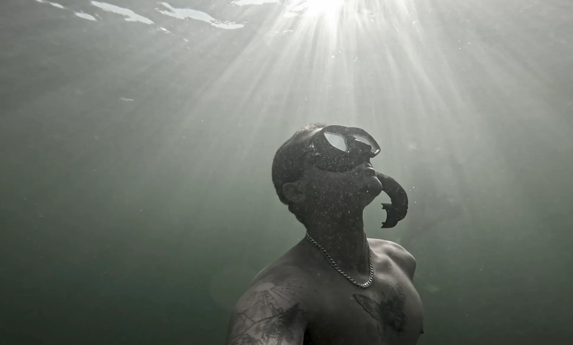 A freediver ascending toward the light